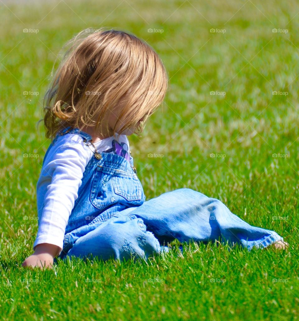 Baby's first spring. Baby enjoying grass in spring