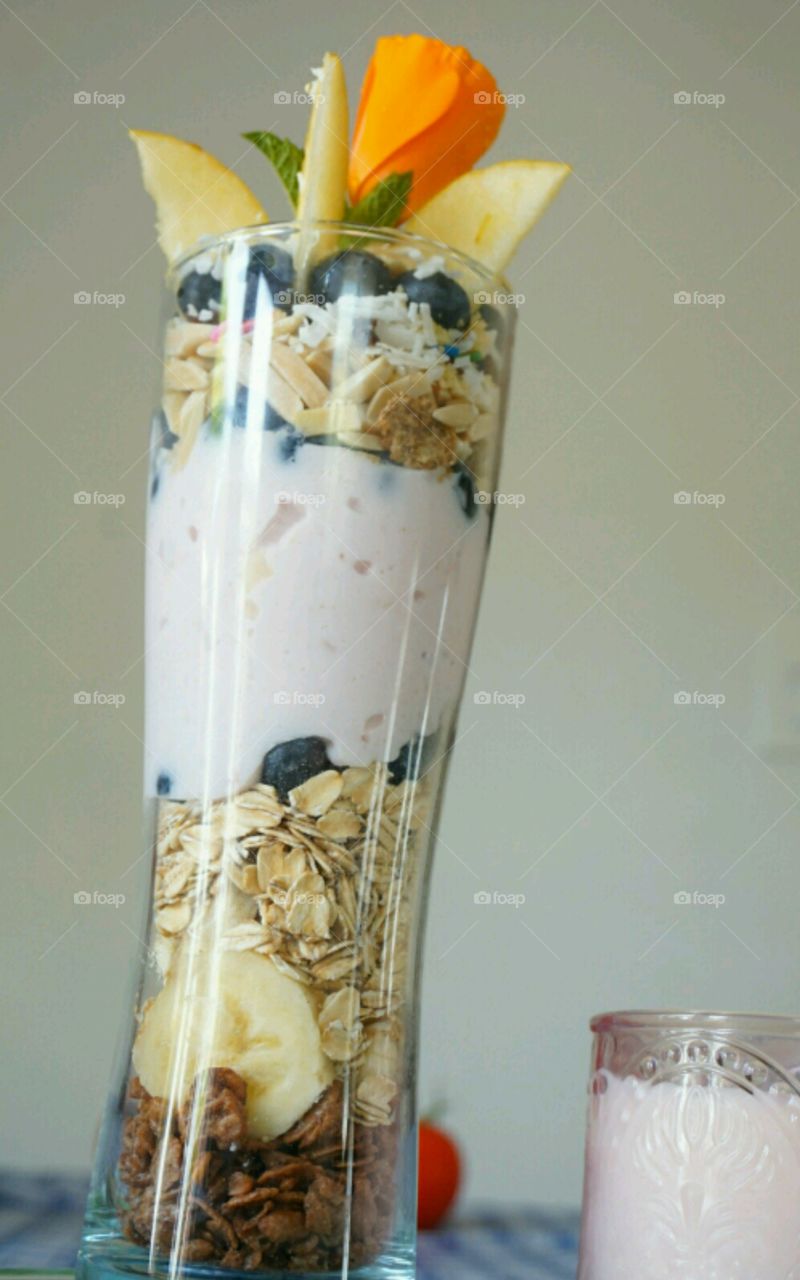 Fresh fruit smoothie - blueberry banana coconut strawberries and nuts