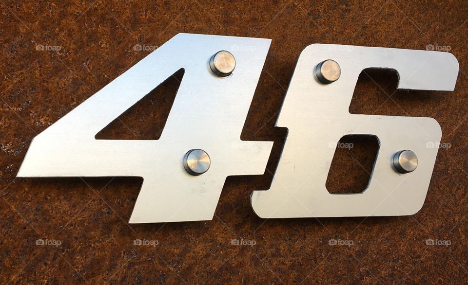 46 house number in the style of Valentino Rossi, motorcycle racer.  Made with Corten steel back plate and aluminium numbers. 