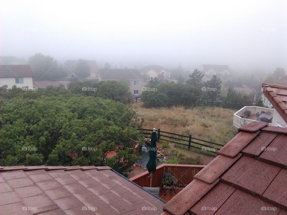 View from a rooftop as fog approaches a Colorado neighborhood.