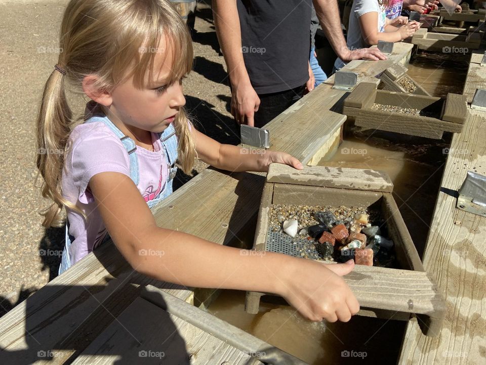 Little girl panning for gemstones 