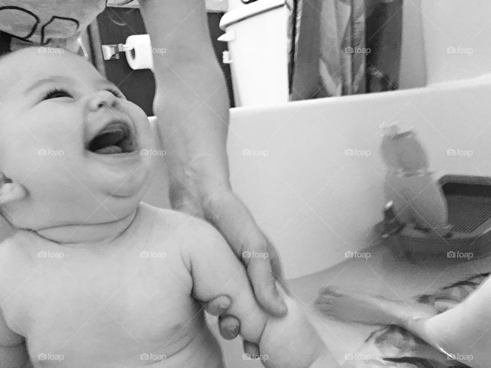 Smiling baby in bath tub