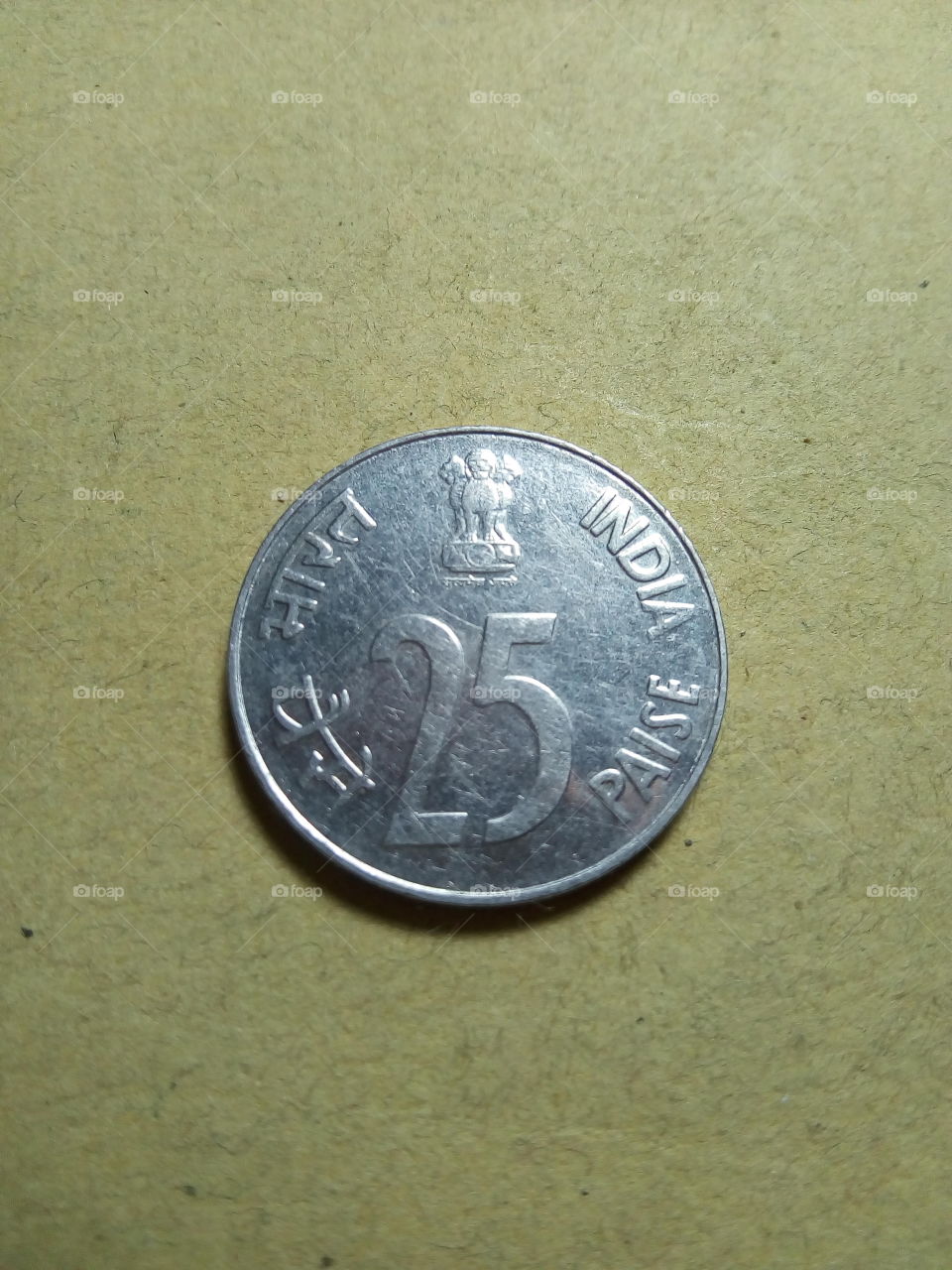 A coin of twenty five paise- 1/4 share of Indian Rupee issued by Government of India in 1988.
