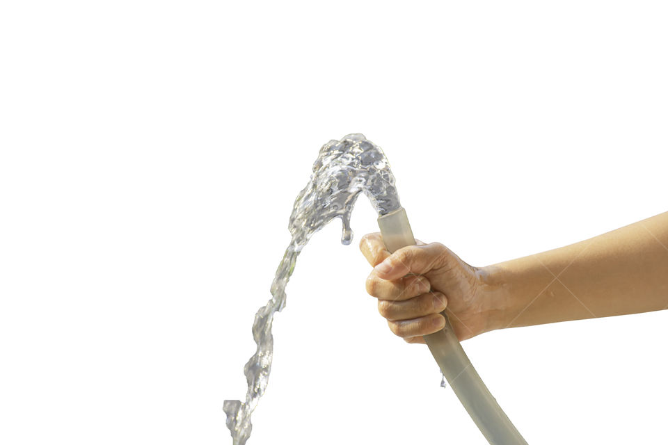 Hand boy holding the rubber tube and the water flows out on a white background with clipping path.