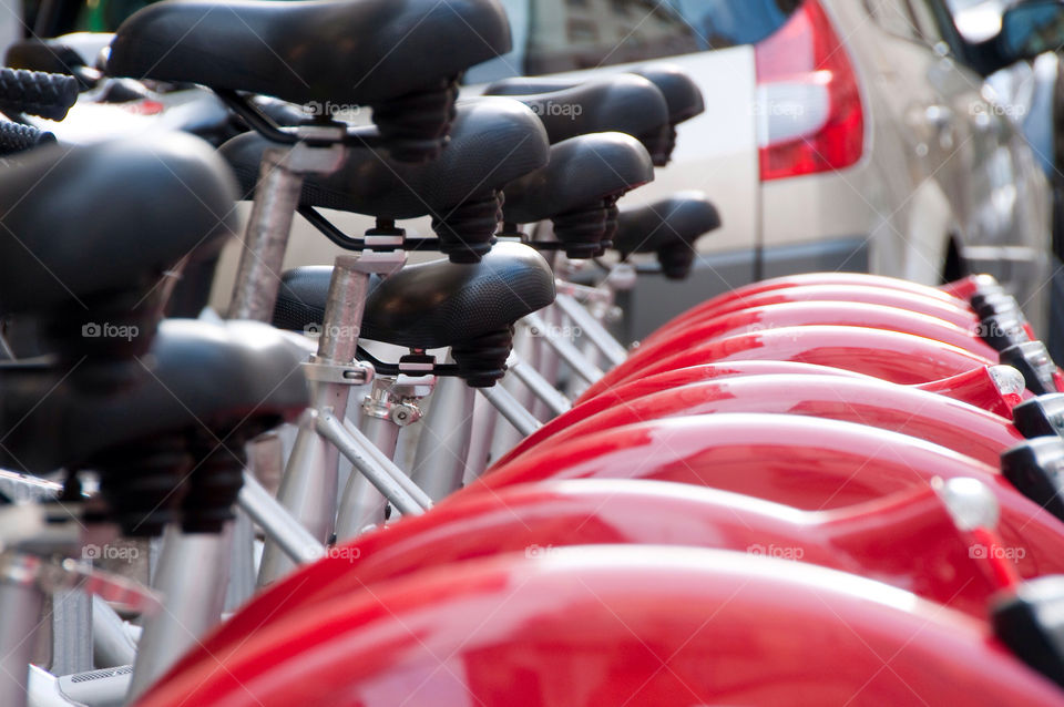 A row of bikes in a bike rack bike rental