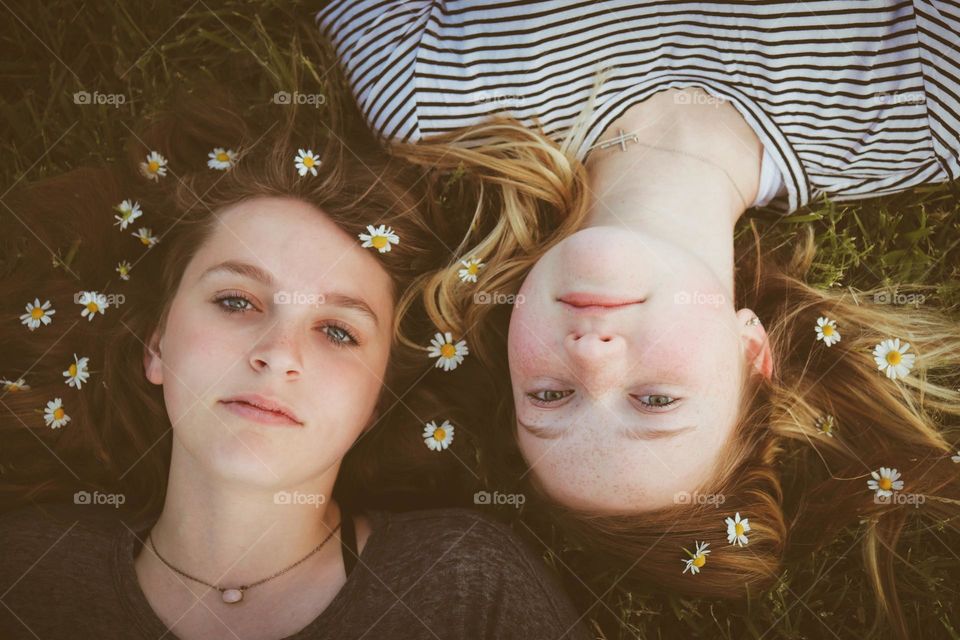 Close up of two girls with flowers in there hair