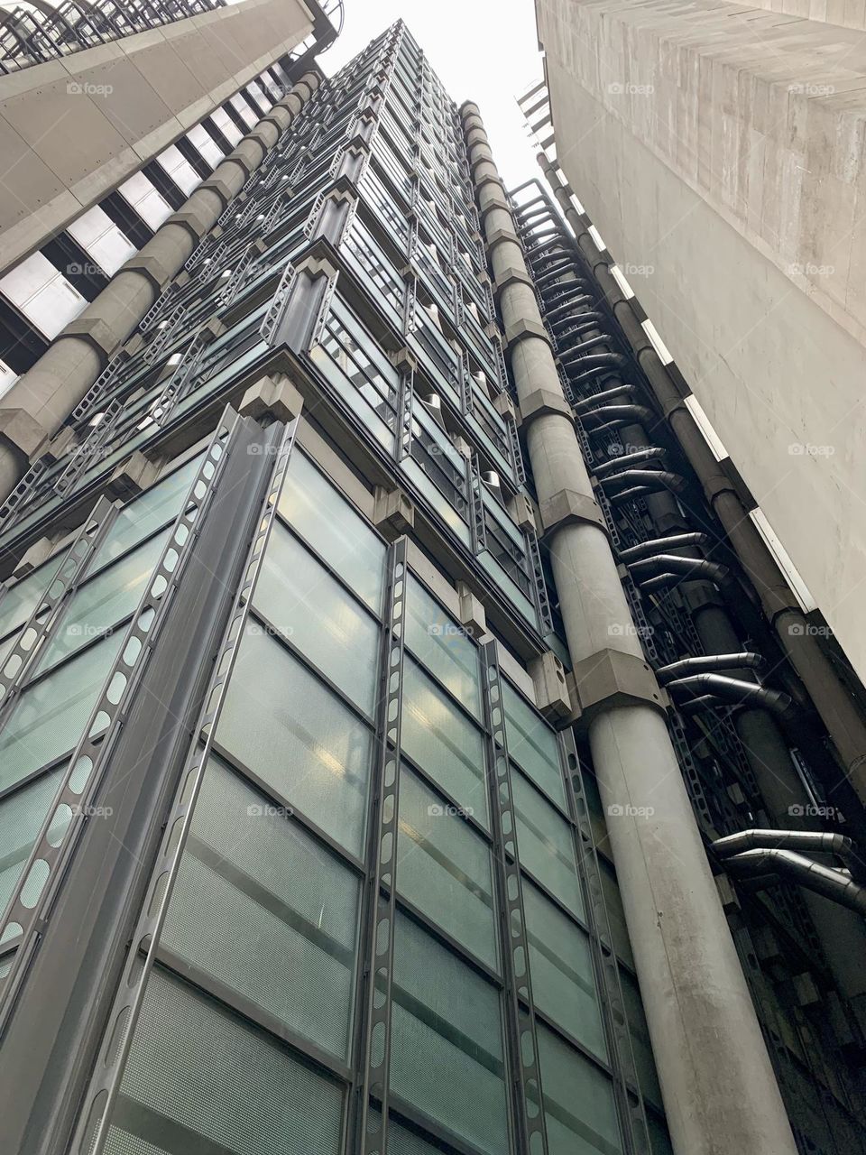 Low angle view of industrial modern building skyscrapers, London, grey color palette