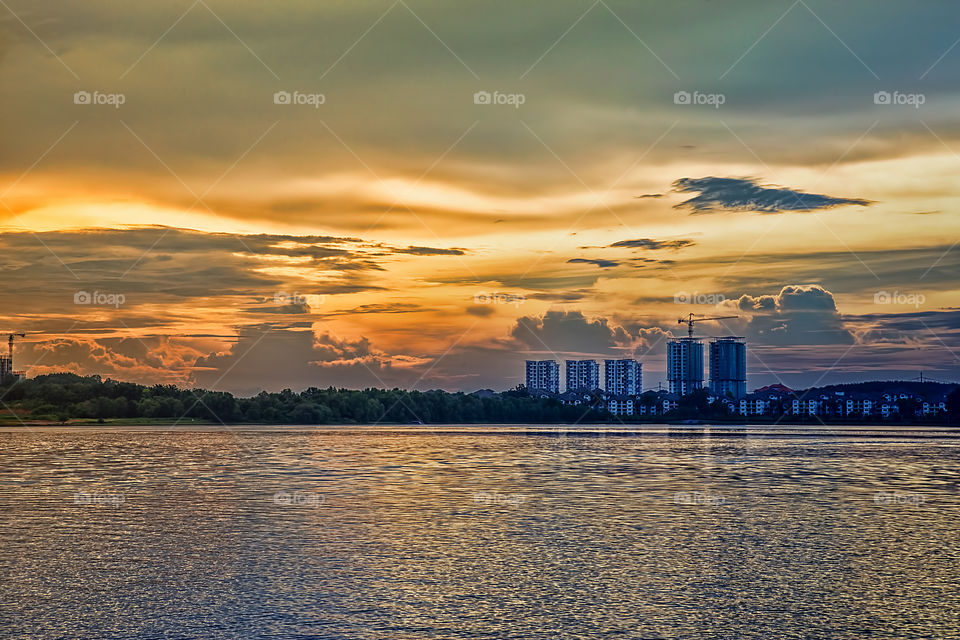 City at waterfront during sunset