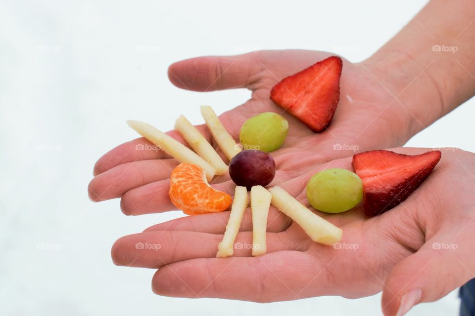 Face made with fruits on hand