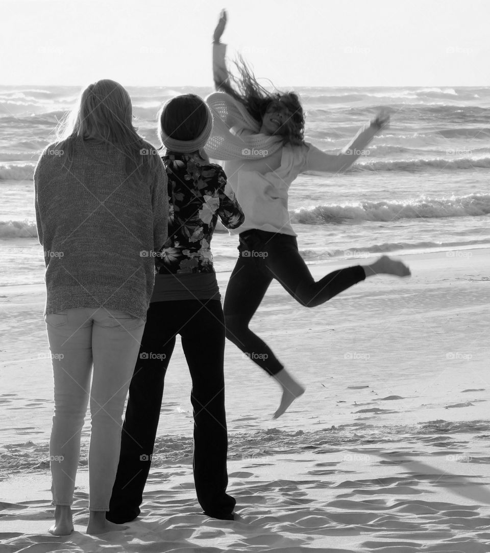 Jumping for joy on a sandy beach in front of the Gulf of Mexico!