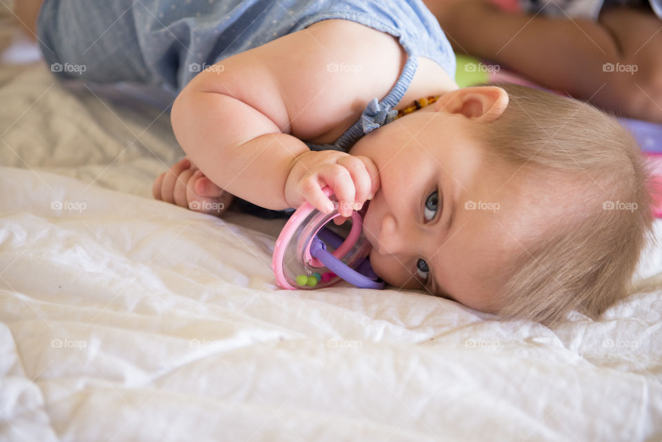 Teething ring in mouth of baby