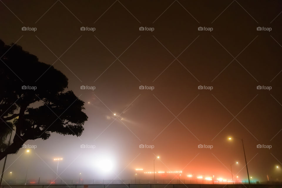 Foggy night in L.A., airplane creeping in through the unbelievable fog like a UFO flying by. 