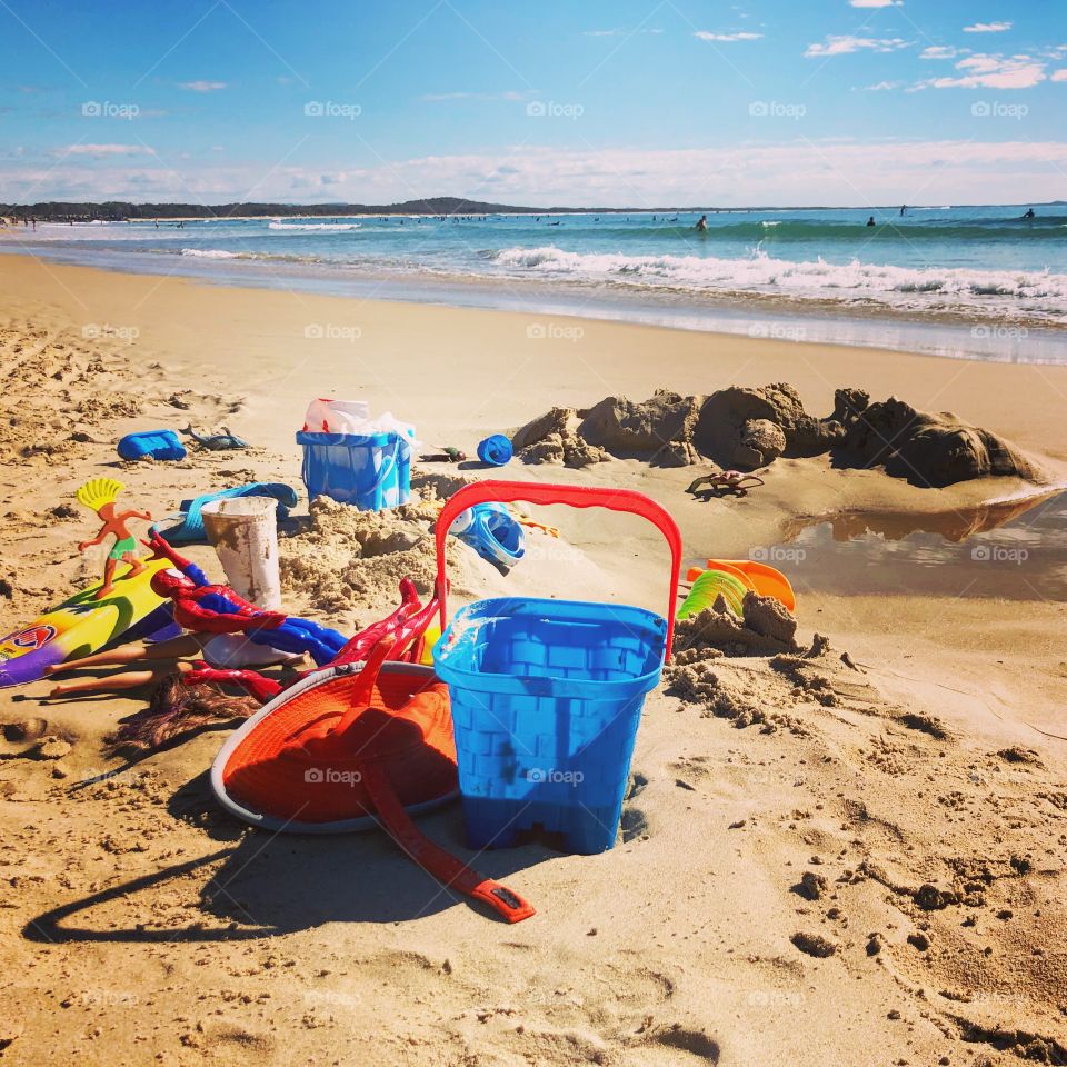 At the beach toys in the sandy beach 