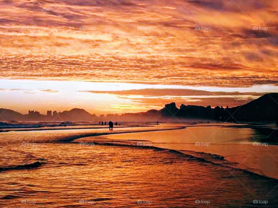 Sea, sky and clouds in orange color