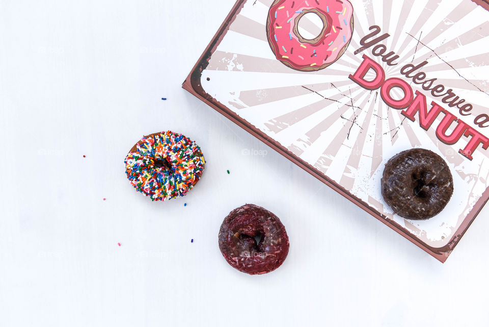 Flat lay of two donuts next to a donut box