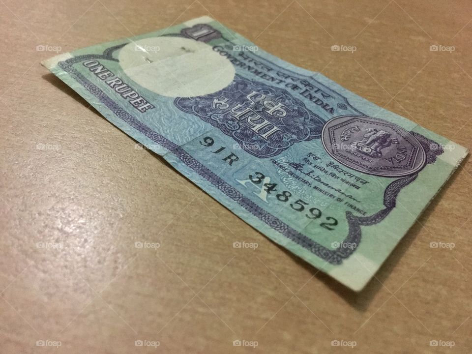 Indian currency of one rupee, the page is old but value is still alive.