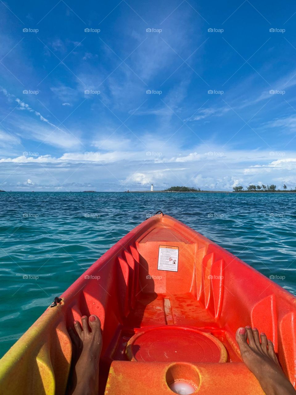 A young person kayaking on beautiful ocean in Bahamas. 