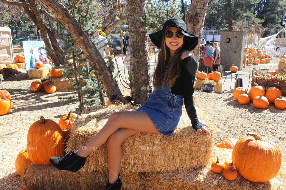 Lovely girl enjoying the fall festivities at the pumpkin patch.
