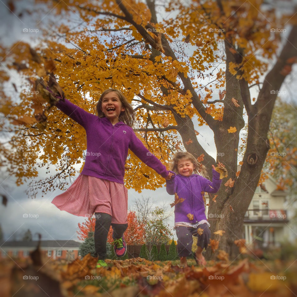 Happy sisters running in park