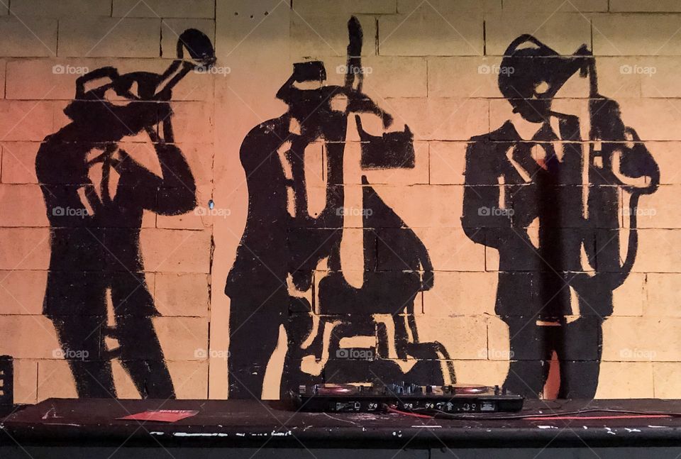 A mural of people playing musical instruments 