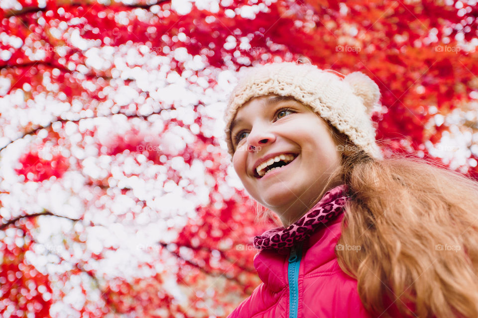 Low angle view of happy girl in autumn