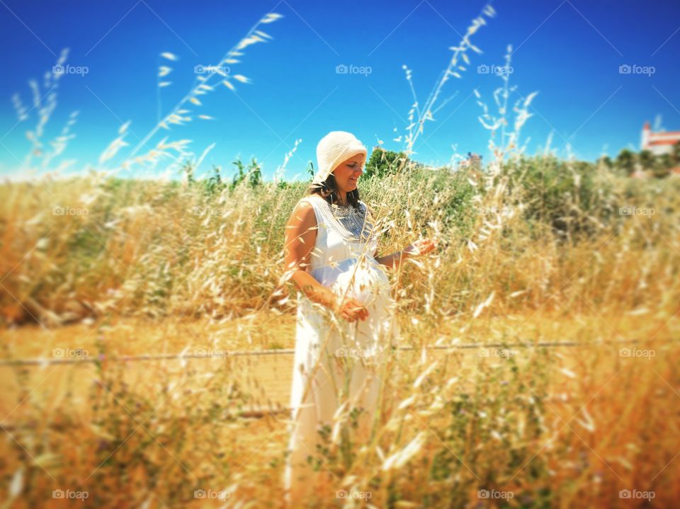 Pregnant woman standing in field