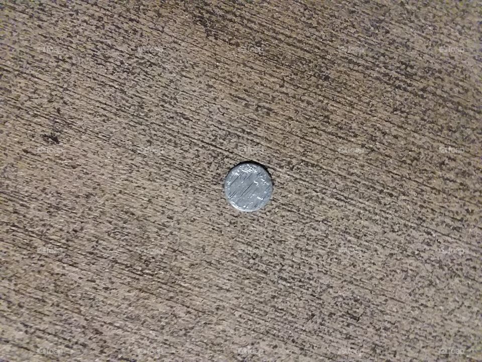 smashed dime in concrete