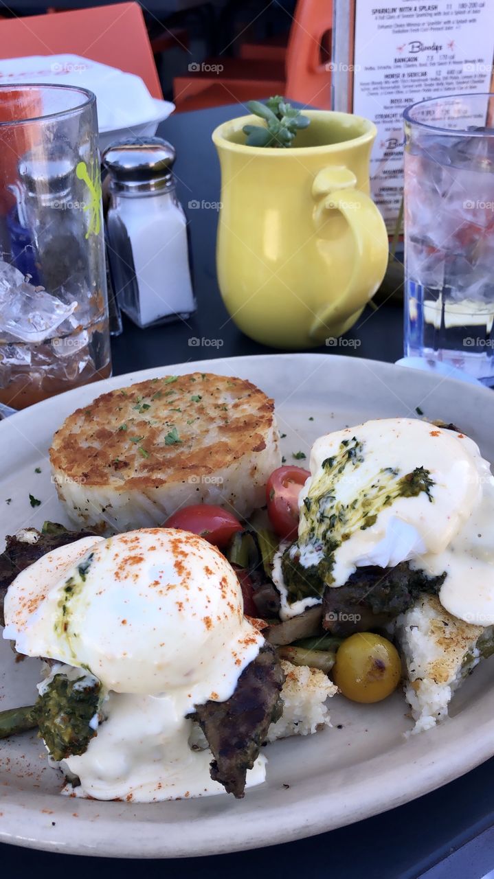 Yummy yummy steak and egg Benedict on top of a grit patty. 