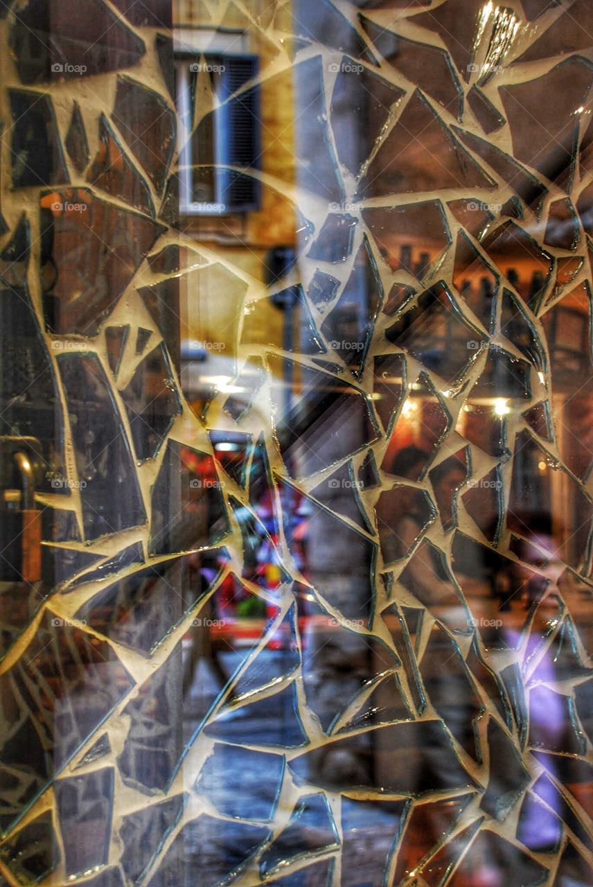 Shattered dreams. Broken mirror mosaic reflects the collar and life of a Roman Street