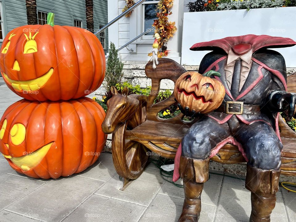 Halloween display of the Headless Horseman sitting on a bench outside a town post office