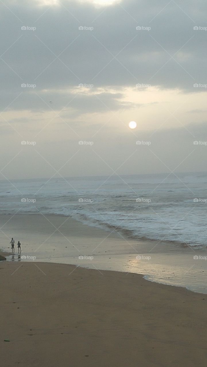 two brothers walking near the beach and beautiful sunset.