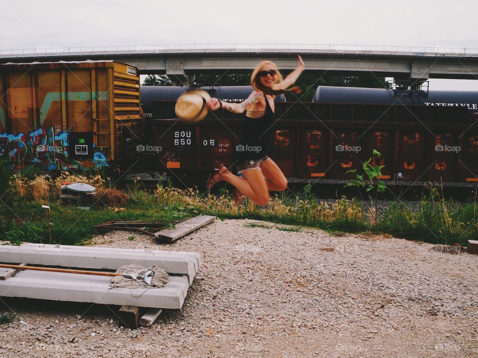 Woman jumping near railway track