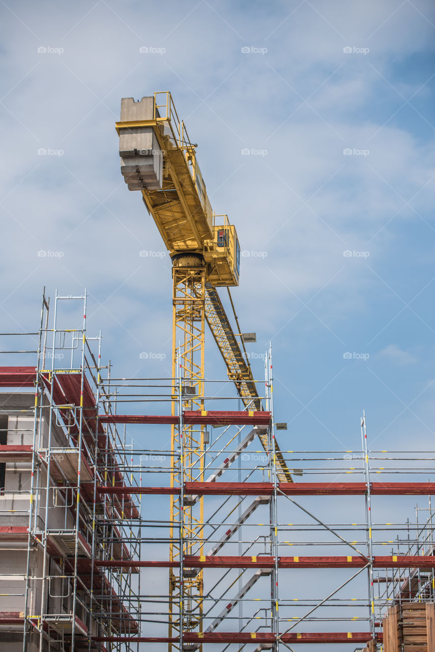 view of the construction site, scaffolding and crane