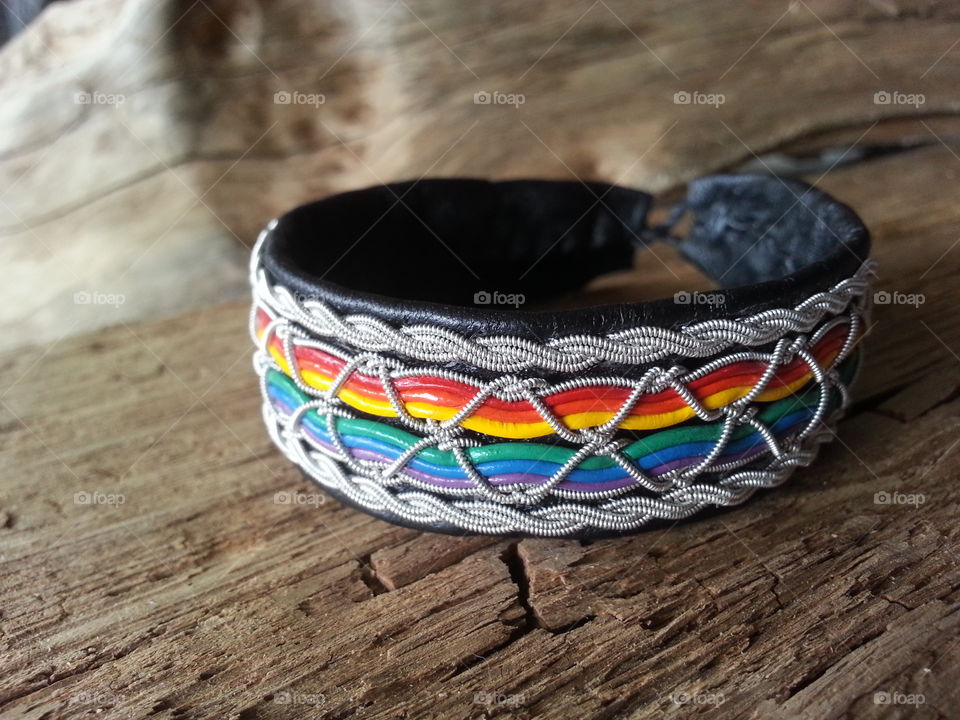 A handmade braclet in the pride color