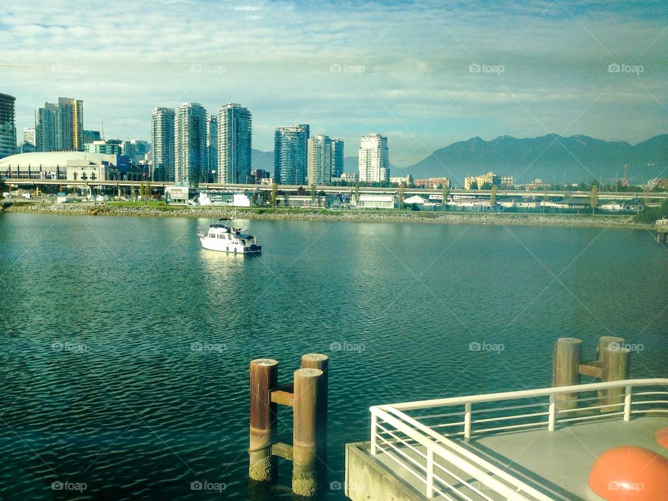Vancouver British Columbia, harbour view with city and mountains in the distance