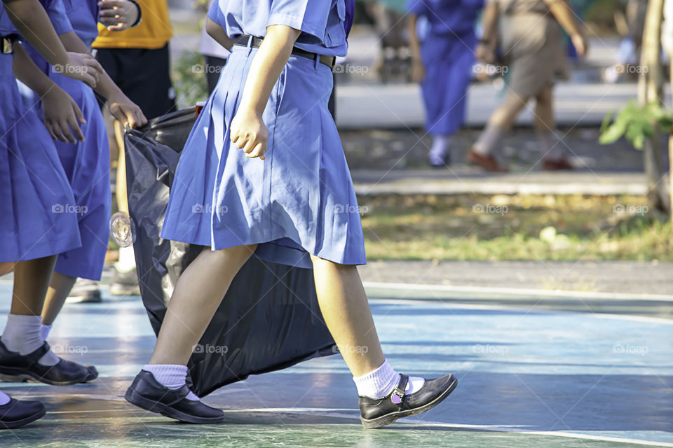 Hand Asean girl holding Black garbage bags.