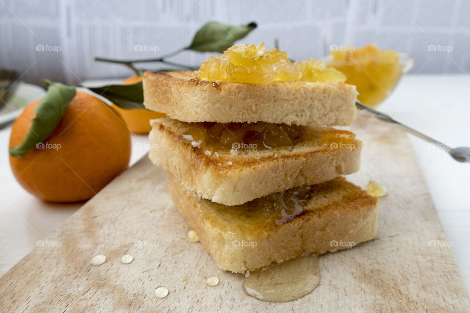 Appetizing toasts with orange jam