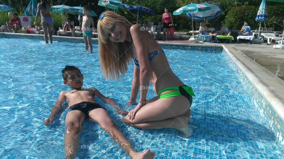 Girl and boy in swimming pool