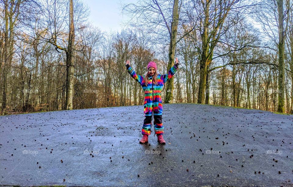 Colourful girl on grey rock