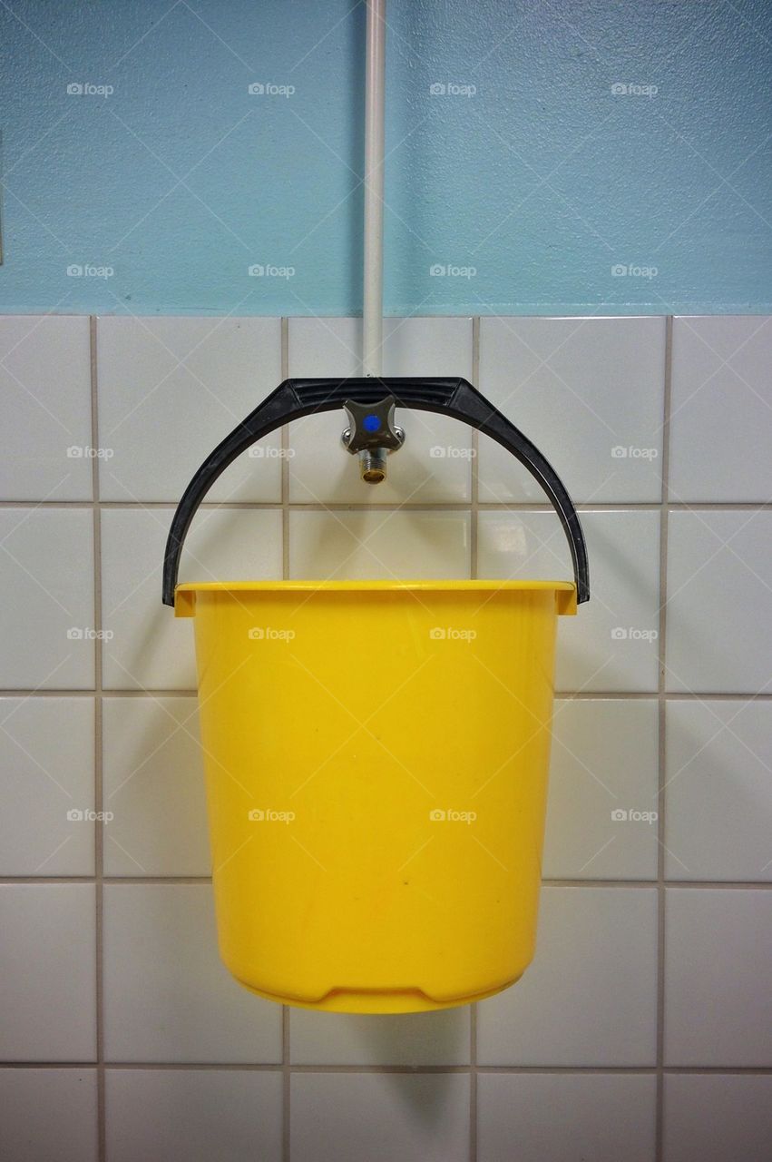Yellow plastic bucket