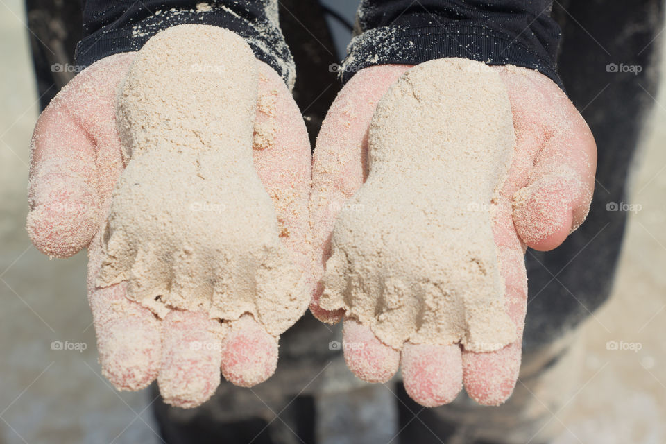 Holding foot shapes made of sand