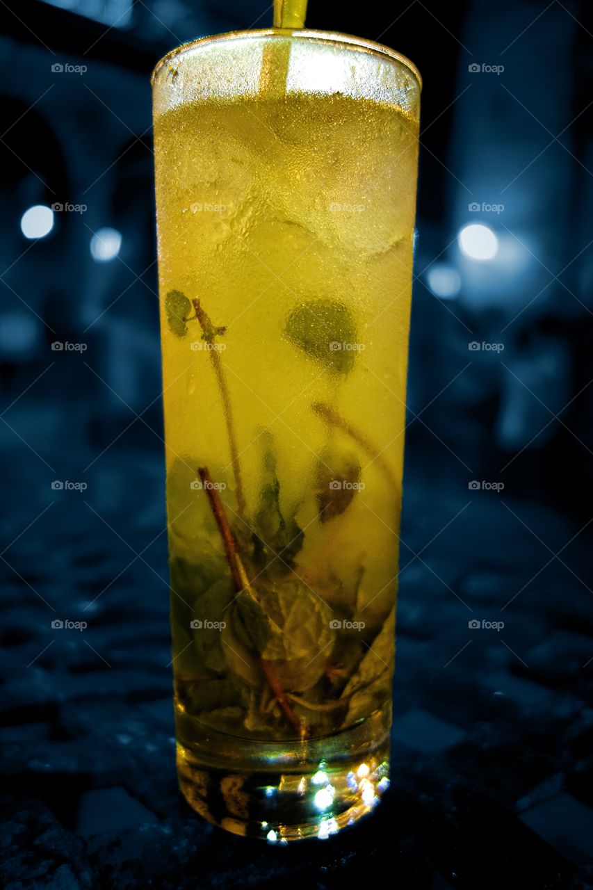 Traditional Cuban Mojito. Traditional Cuban mojito served ice cold at an outdoors terrace in the old town of Havana, Cuba.