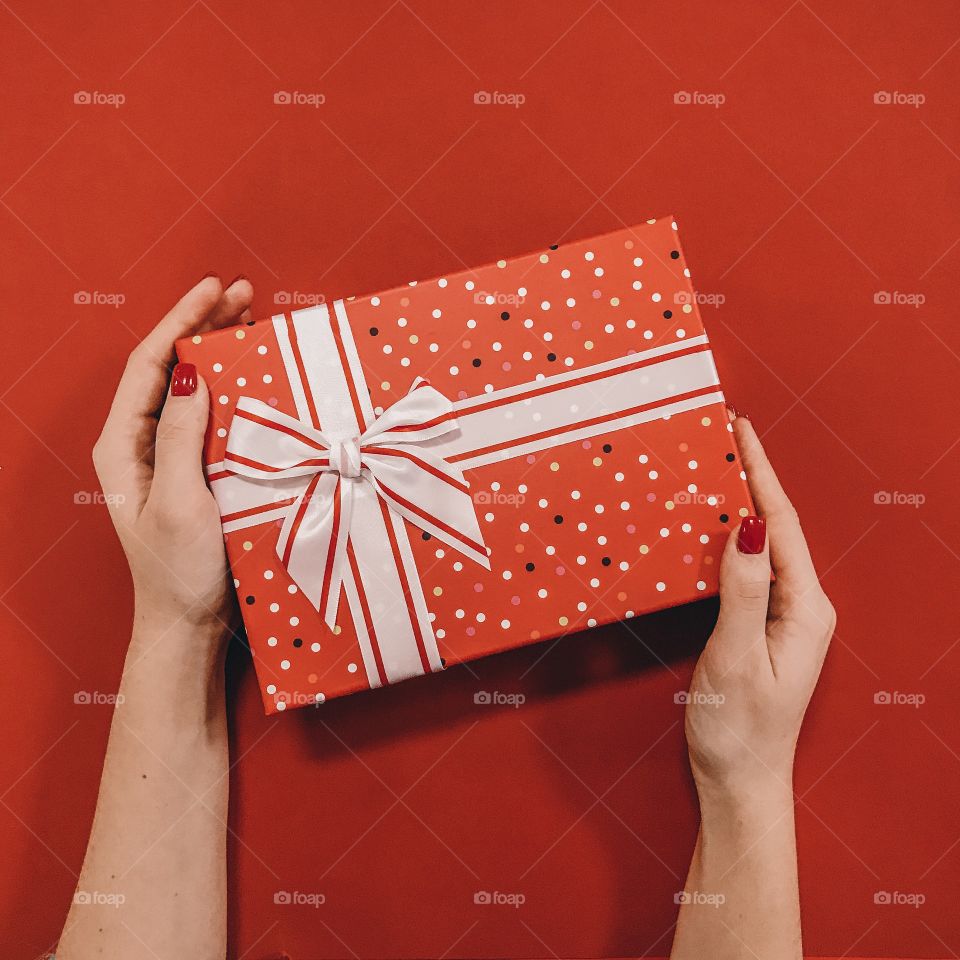 Red gift box on red background