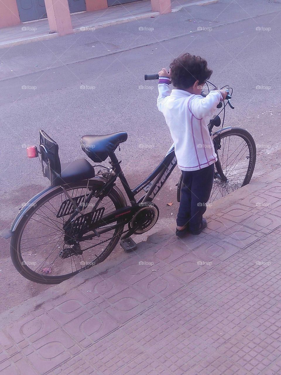 A small child tried to drive its bicycle.