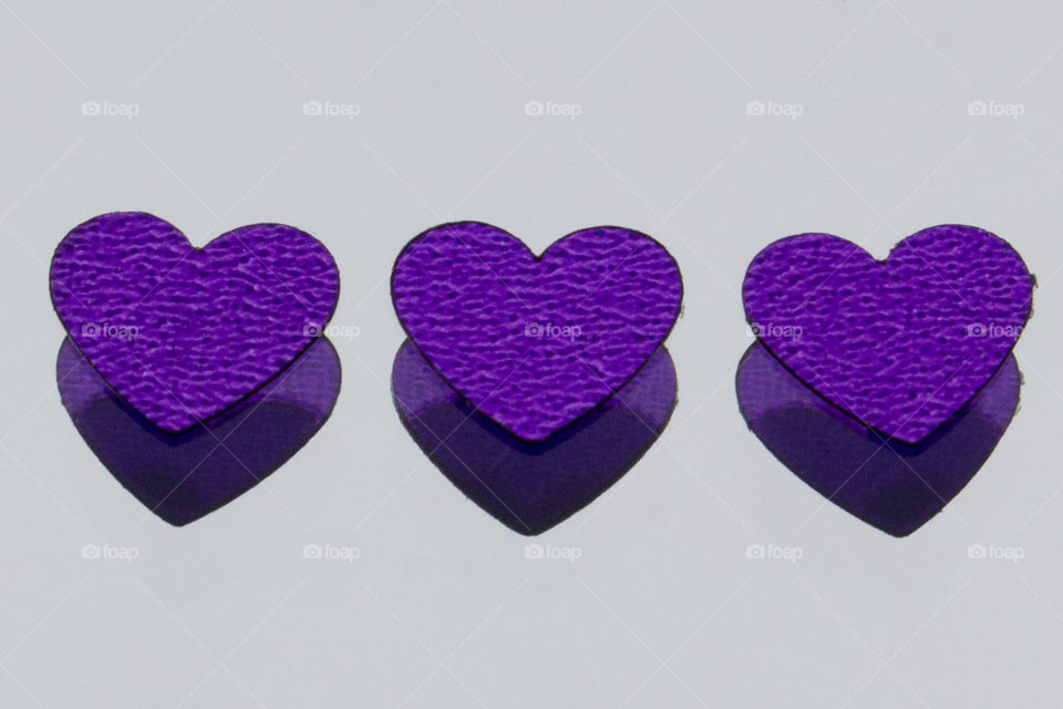 Three purple hearts reflections 