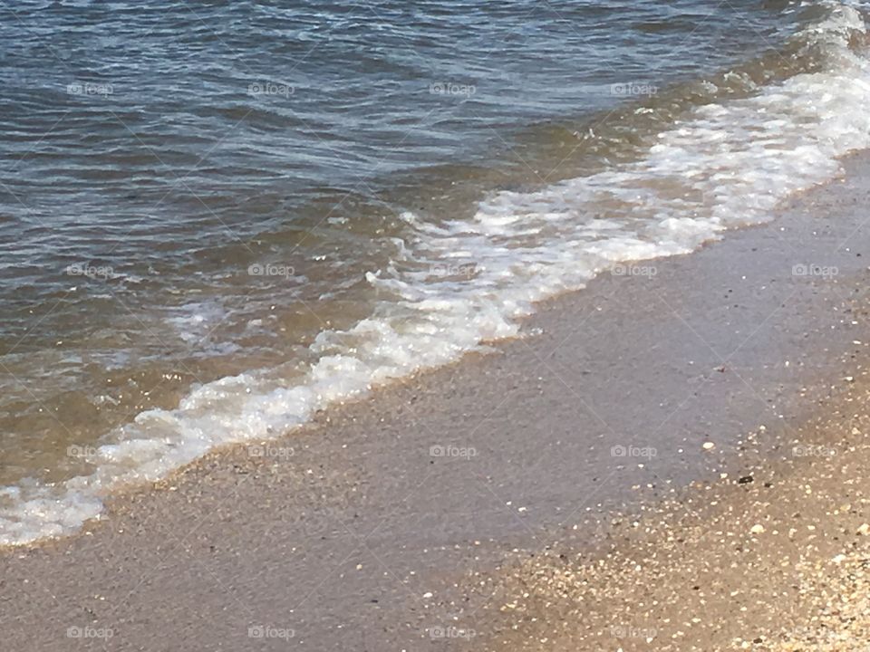 Ocean water waves on the beach.