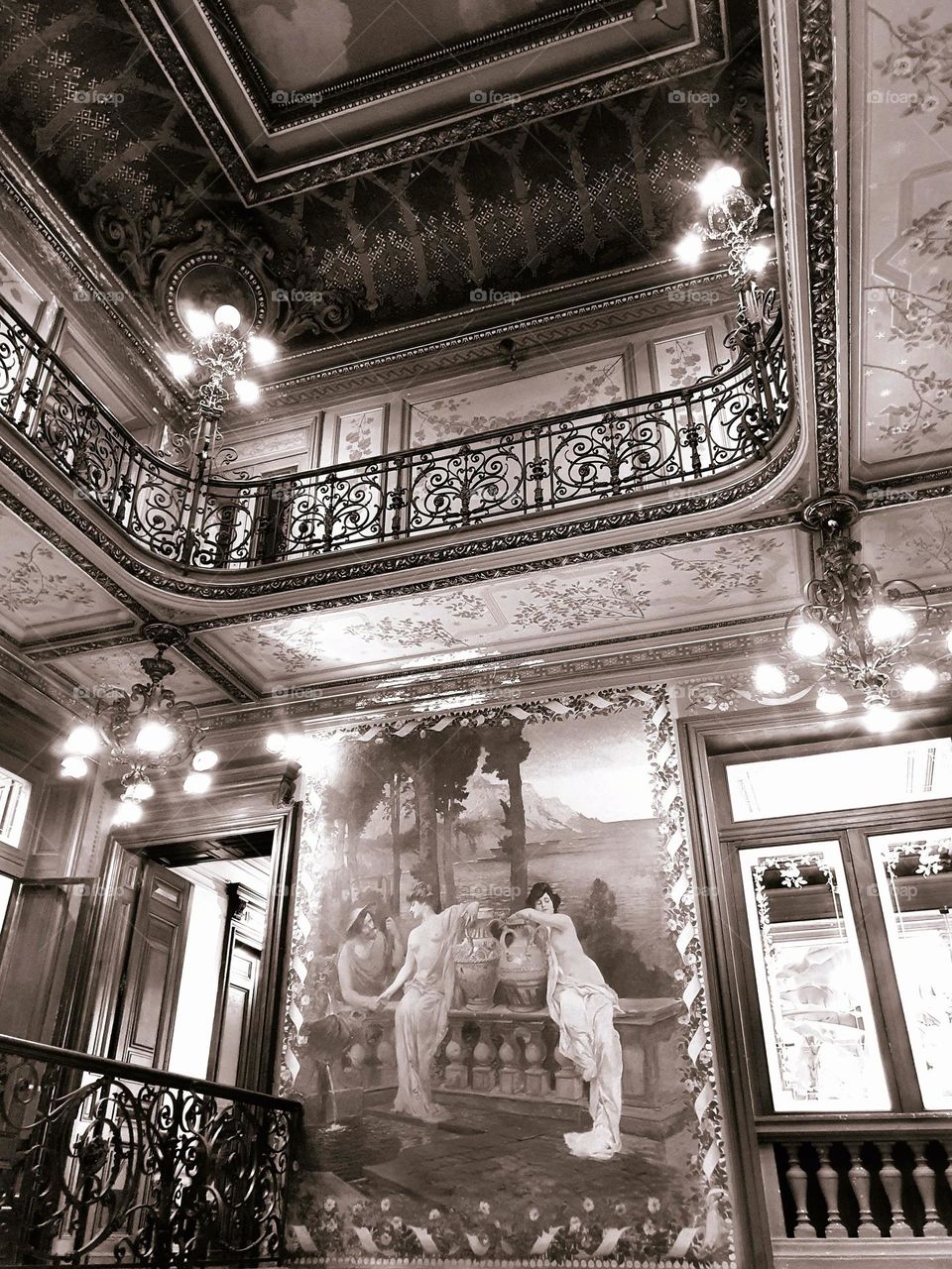 Vintage sepia shot of Hotel Pams Art Nouveau's interior staircase with its frescoes and wrought iron railings, in Perpignan