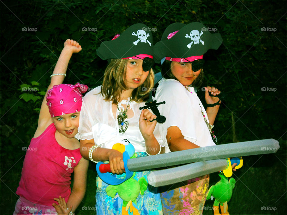My three crazy & colourful daughters! It was pirate day for their water sport course and they were dressed the part! Complete with pirate hats, bandanas, parrots, swords, lots of bling, eyepatches, and a very enthusiastic pink powder monkey! 🐒