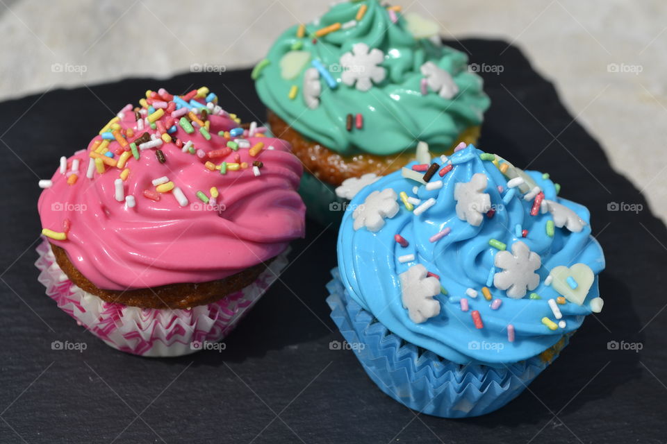 Tasty colorful cupcakes in plate