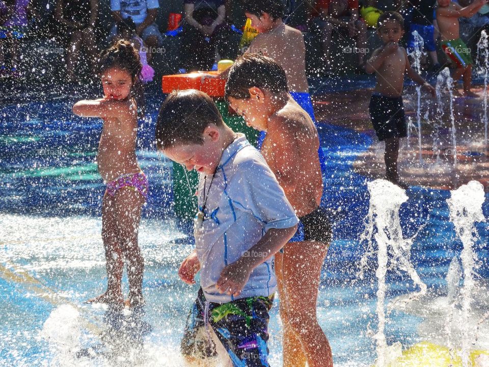 Children Splashing In A Fountain